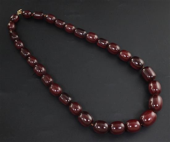 A single strand graduated simulated cherry amber bead necklace, 56cm.